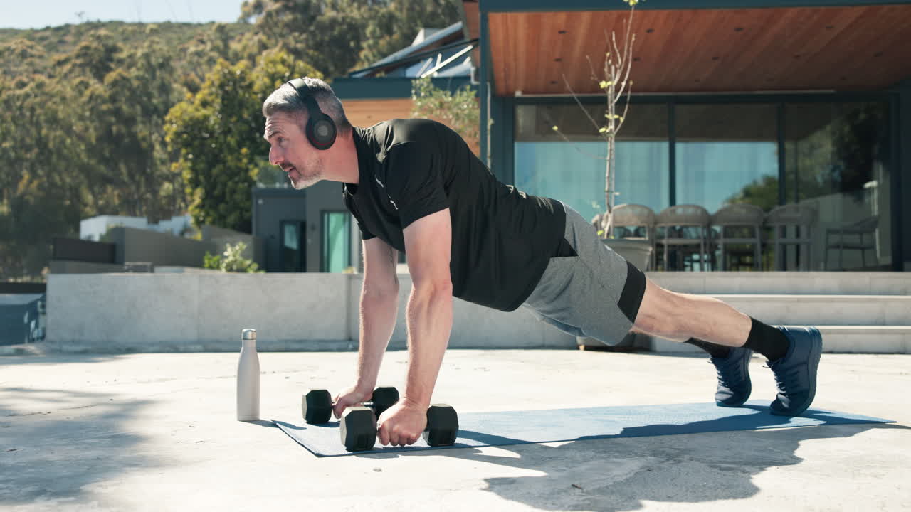 Man Doing Push-Ups with Dumbbells During Outdoor Workout