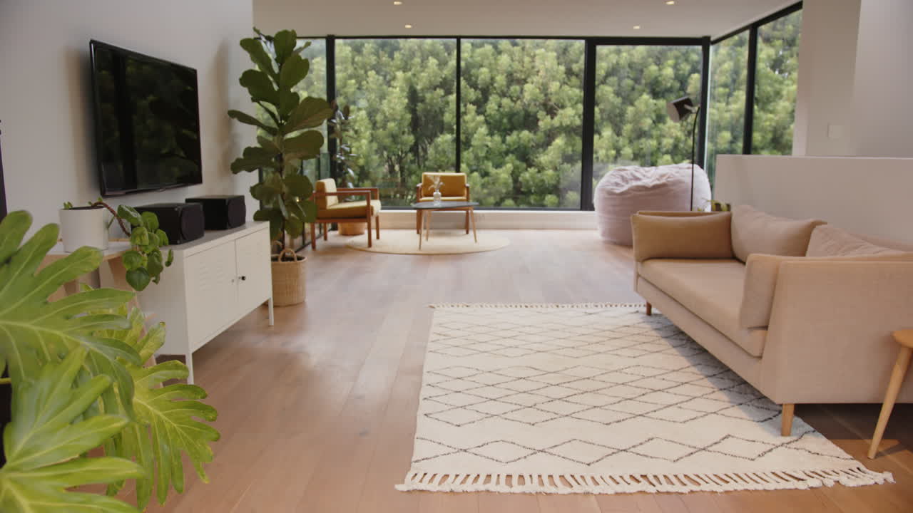 Modern living room with large windows, cozy sofa, and indoor plants, copy space