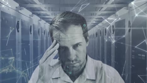 portrait of worried man with computer servers in tech room, scientific data processing and network o