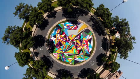 colorful geometric mural on a roundabout