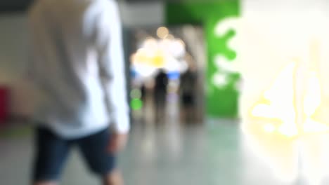blurred image of people walking in an indoor space