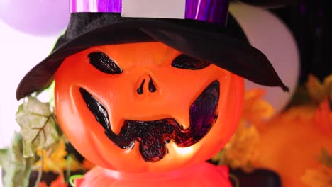 plastic pumpkin with halloween lantern shaped hat in colorful decoration