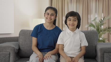 happy indian sibling talking to the camera