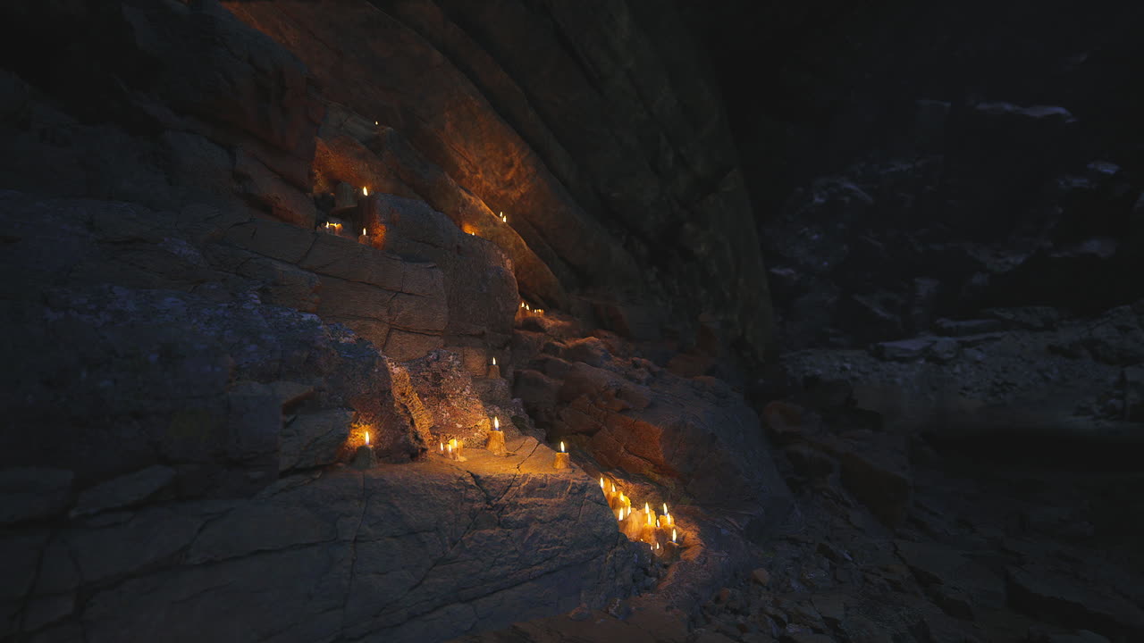 Flickering candlelight illuminates rocky cave pathway at night