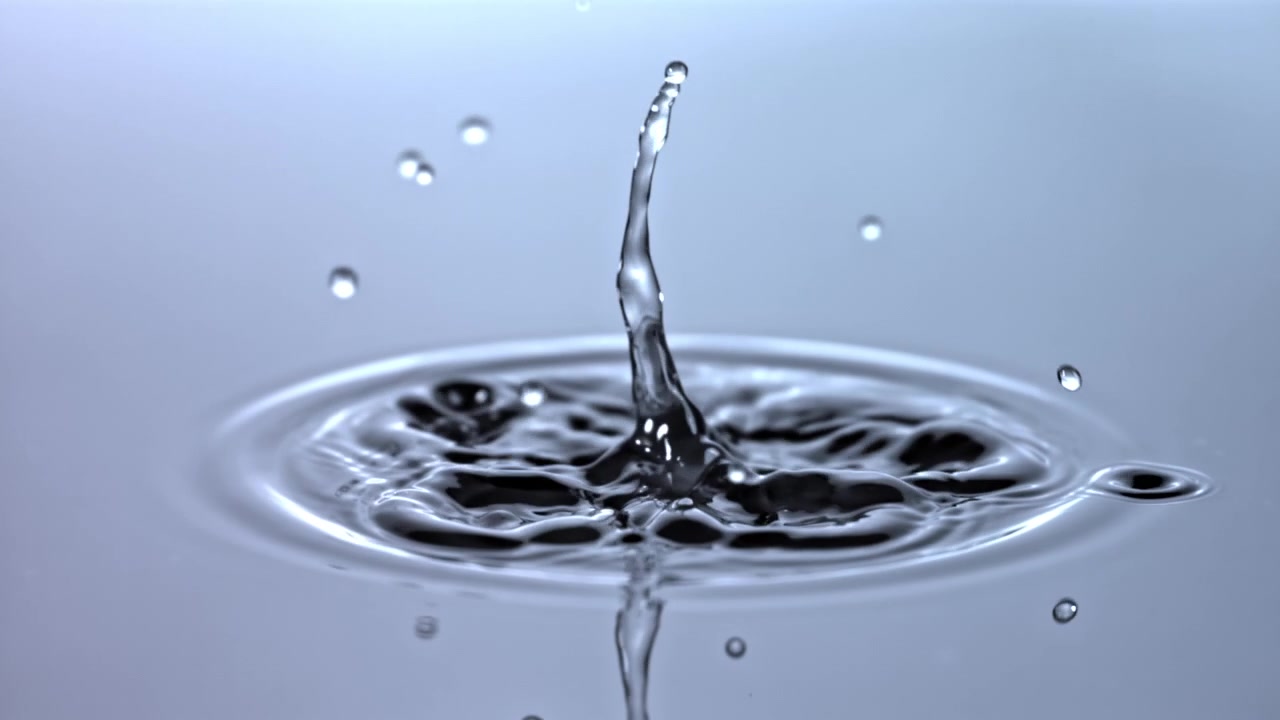 Slow Motion Water Droplet Falling and Splashing on a Calm Surface