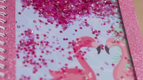 front cover of pink custom made notebook with sequins and flamingoes, establisher