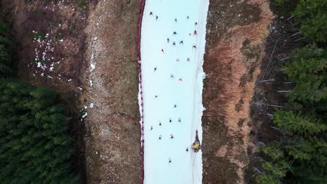 Aerial-view-of-people-skiing-downhill-on-snowy-Dolni-Morava-mountain-slope