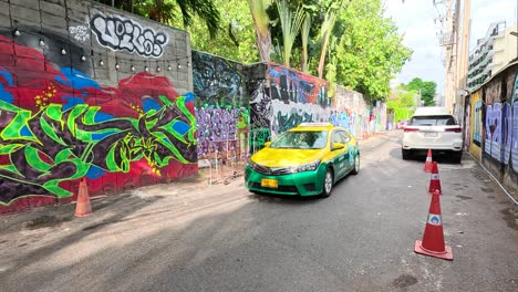 colorful thai street scene with graffiti and transportation