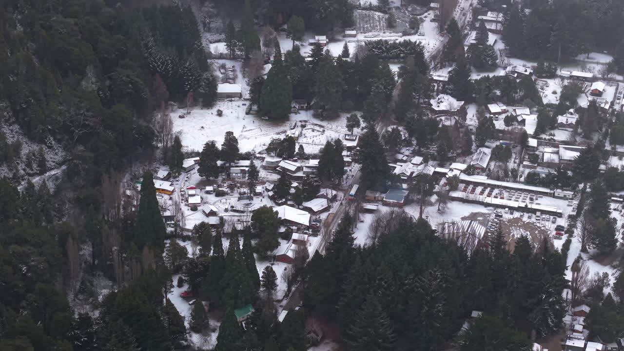 Panning aerial movement over the Colonia Suiza town in the municipality of Bariloche in wintertime, Argentina.