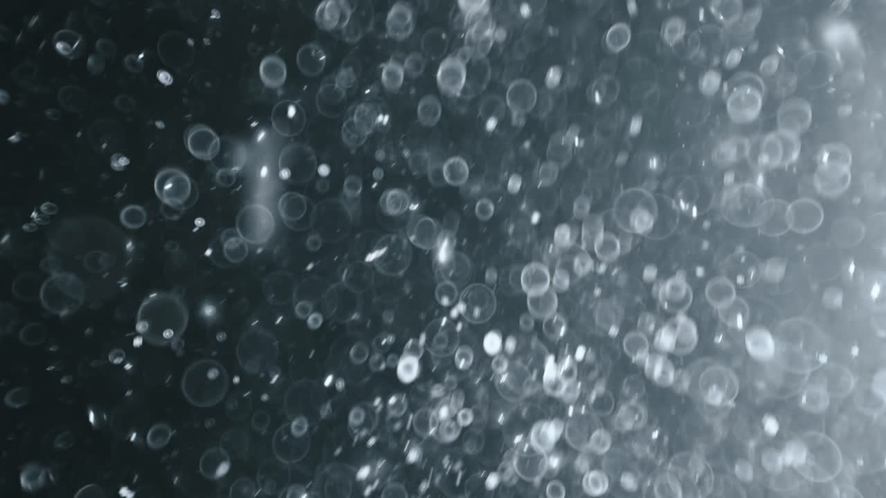 어두운 배경에 떠 있는 추상 입자 보케