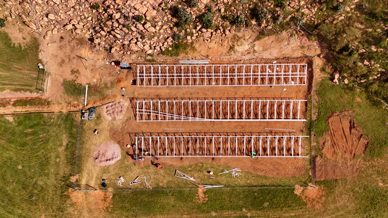 Top view of a solar power support structure installation in progress outdoors