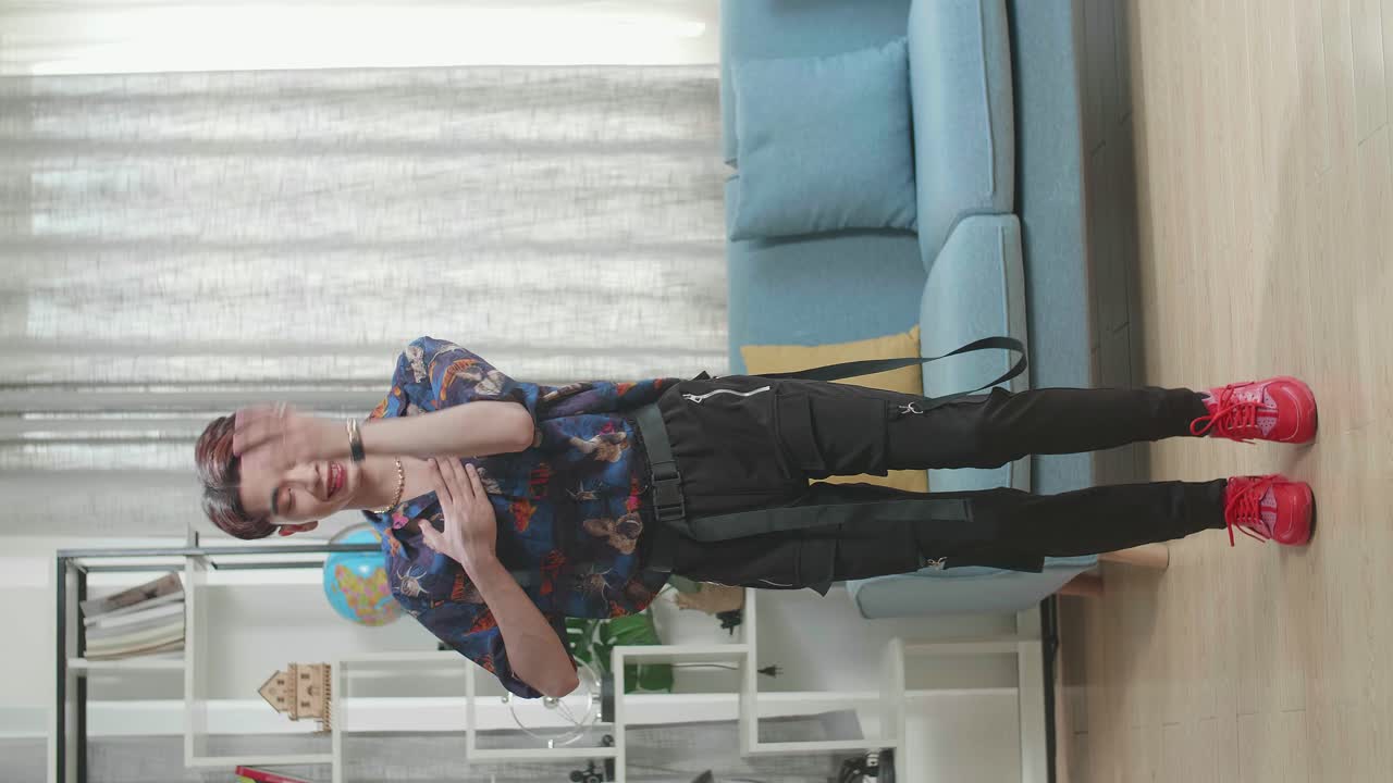 Full Body Of Asian Transgender Male Dancing While Shooting Video Content For Social Networks At Home