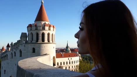 woman admiring a historic european castle
