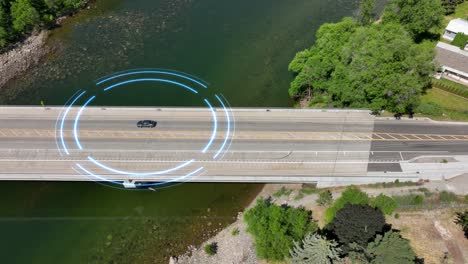 aerial view of a self driving car passing over a bridge