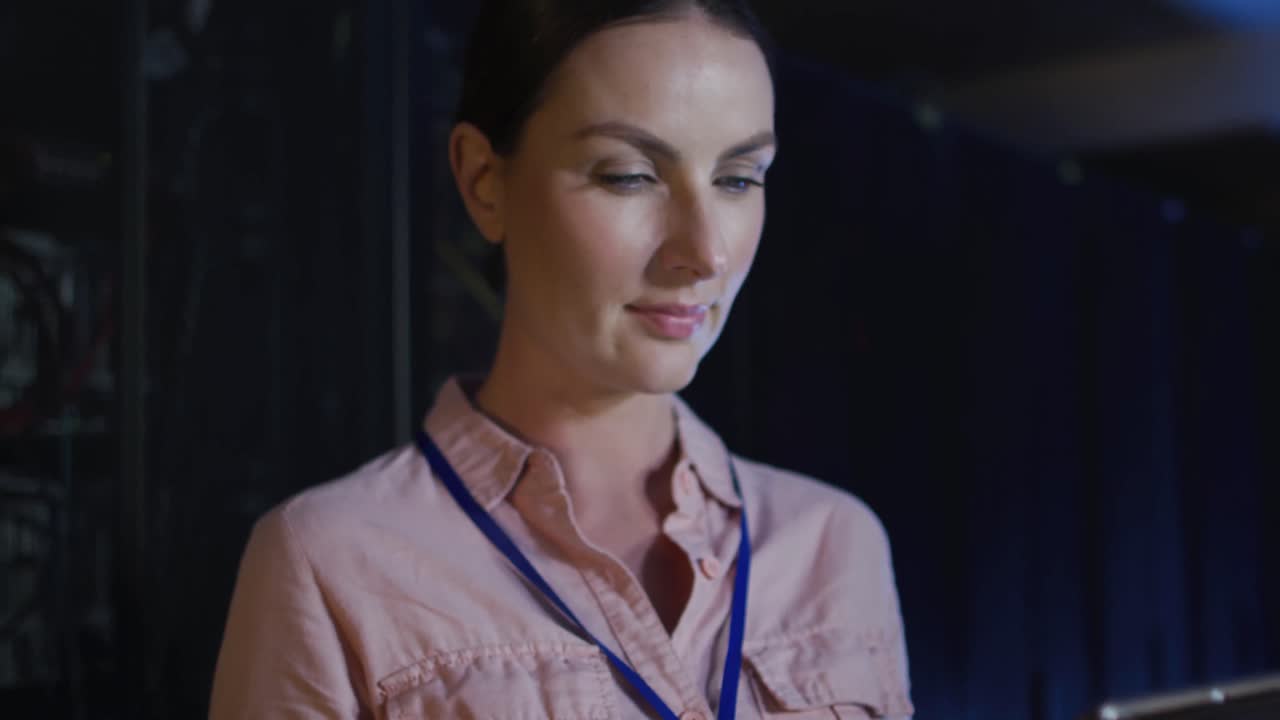 técnica informática caucásica que usa una tableta para comprobar el servidor de la computadora