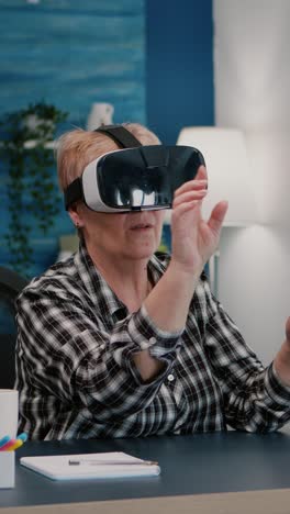 vertical video: retired woman experiencing virtual reality using vr headset at home