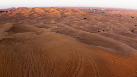 Aerial-View-Of-4X4-Vehicle-Offroading-On-Desert-Sand-Dunes