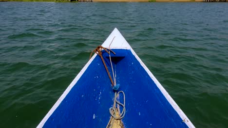 Wooden-fishing-boat-arriving-at-its-destination-on-an-island