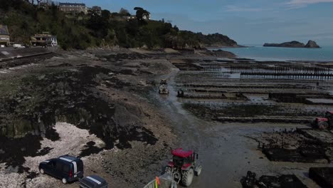 Aerial-4K-Drone-footage-of-a-large-oyster-farm,-Terrain-de-culture-d‘huîtres,-on-the-beach-of-Cancele,-Brittany,-France