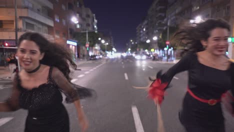 two witches running through a city street at night