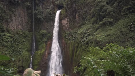 this image captures the slender, powerful stream of the catarata del toro waterfall as it plunges dramatically down a sheer cliff face