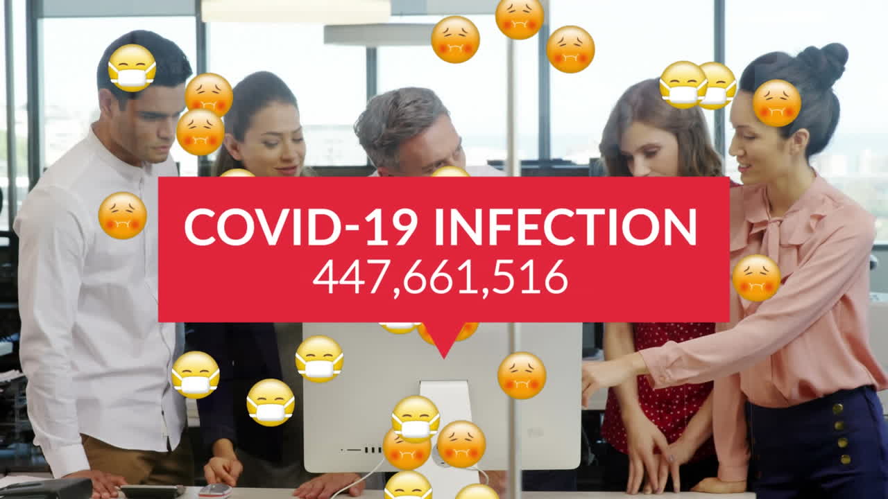 Animation of covid 19 data and sick emojis with face masks over business people with computer