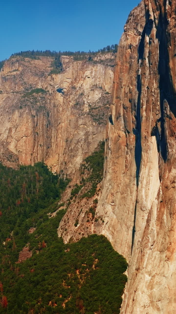 Brown cliff rocks on clear sunny daytime. Stunning mountains of Yosemite National Park, California, USA. Vertical video