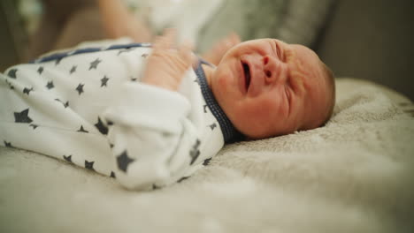 newborn baby crying on blanket day one