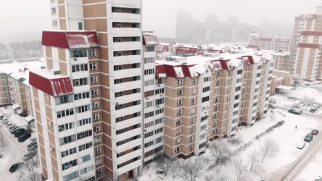 snowy cityscape with apartment buildings