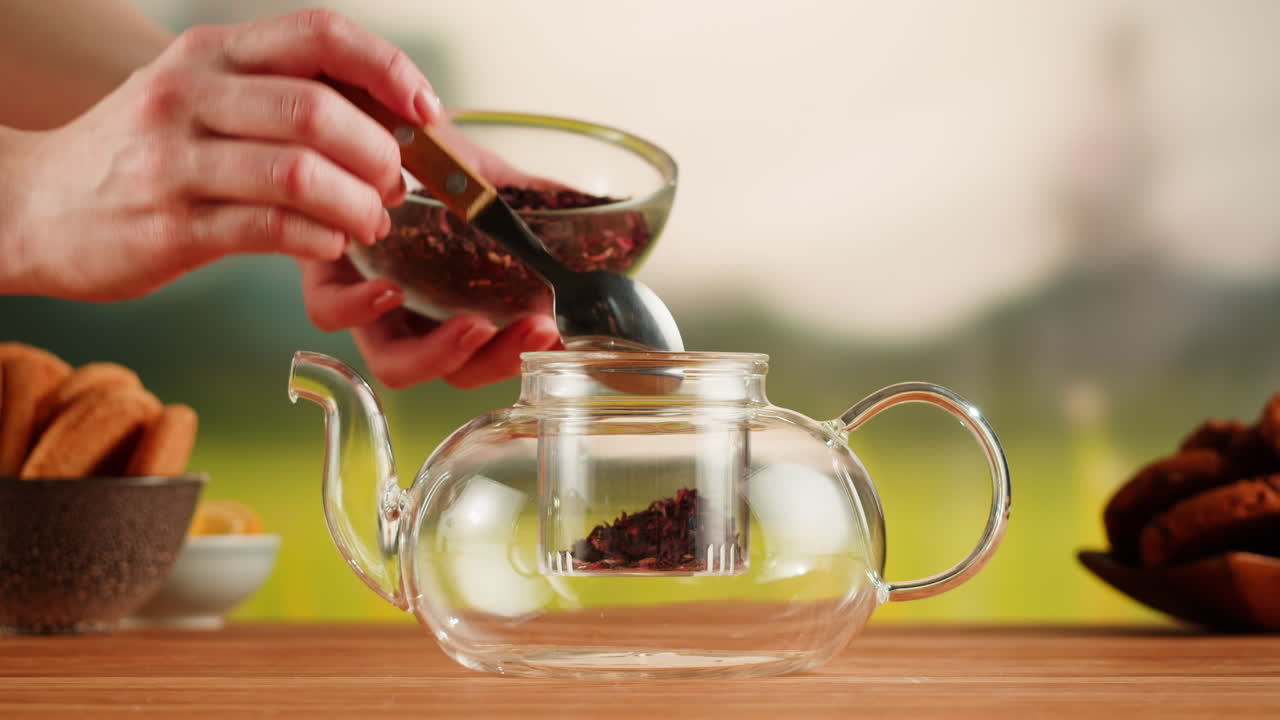 Preparing Herbal Tea in a Glass Teapot