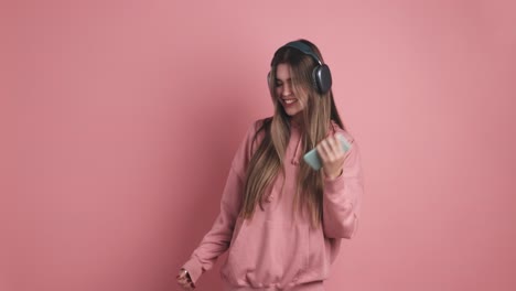 cheerful young woman with headphones and smartphone