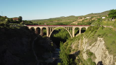 Drone-flying-over-a-bridge-in-a-sunny-day