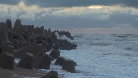 stormy sea waves hitting the port pier in slow motion