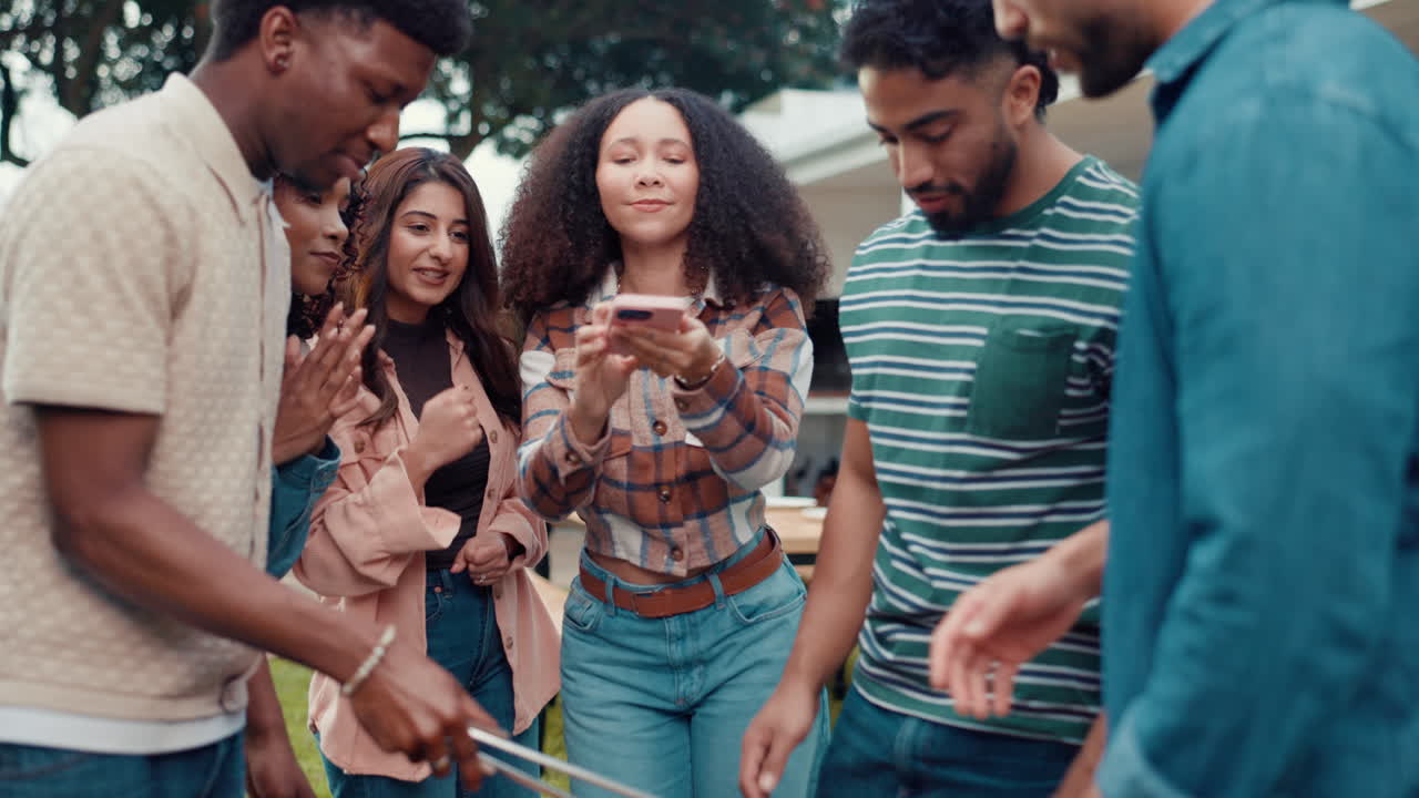 Friends Enjoying a Fun Gathering and Taking Pictures with a Phone