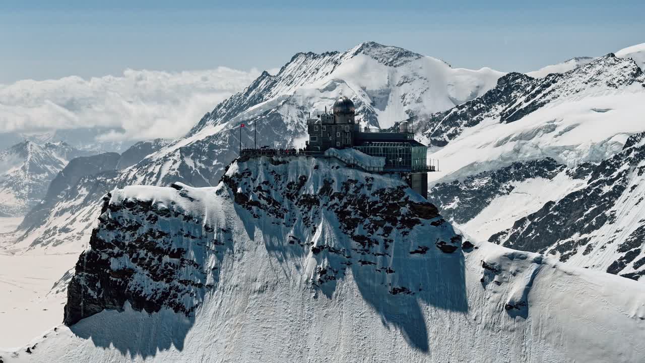 Circling Timelapse of Jungfraujoch Station with Snowy Peaks and Clouds