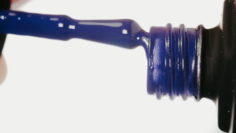 applying dark blue nail polish