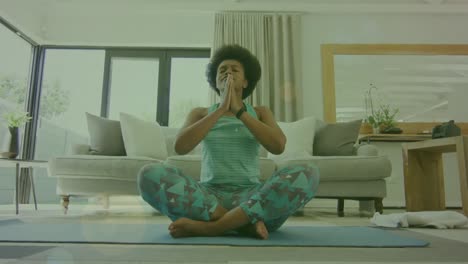 Animación-De-Puntos-De-Luz-Sobre-Una-Mujer-Afroamericana-Haciendo-Yoga