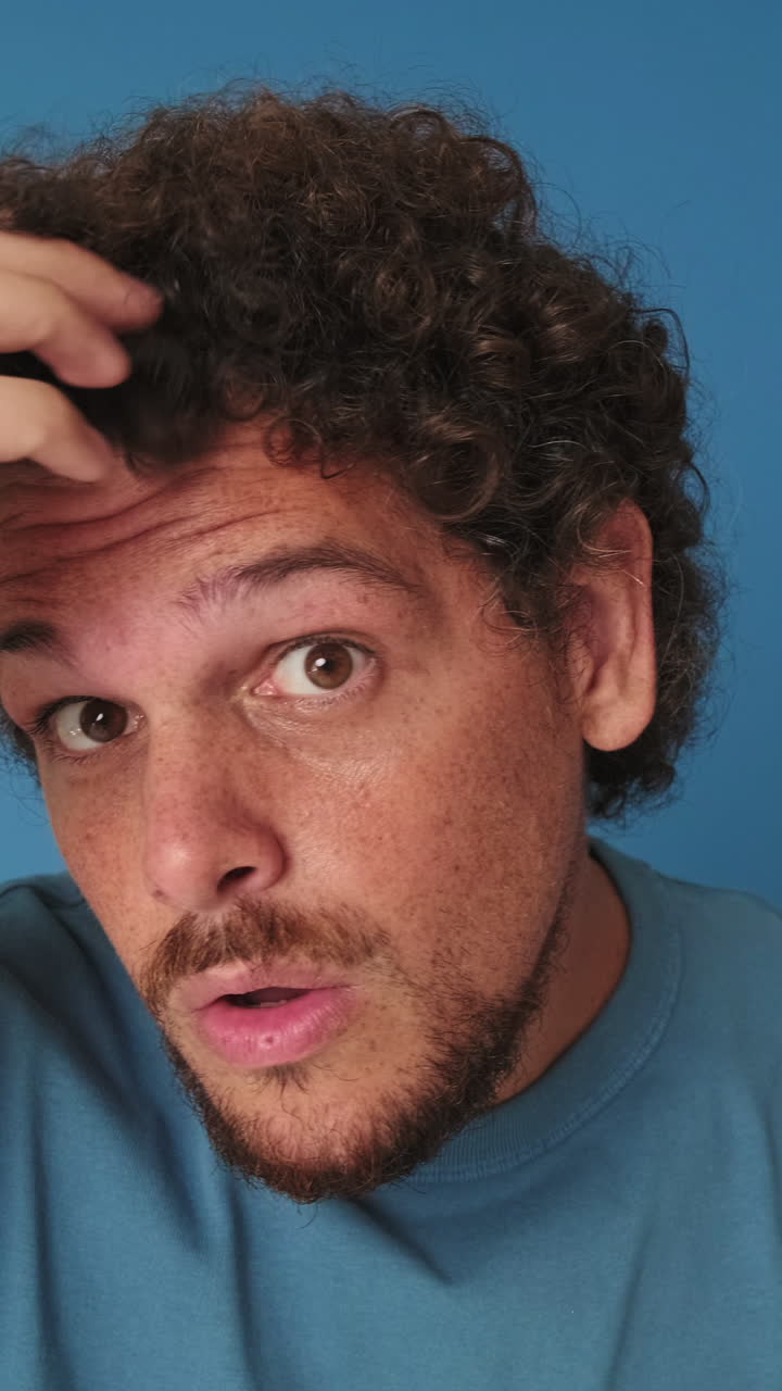 Close-up of Surprised Man with Curly Hair Reacting and Smiling