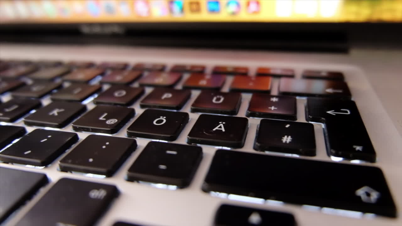 Close up of a black laptop keyboard in daylight