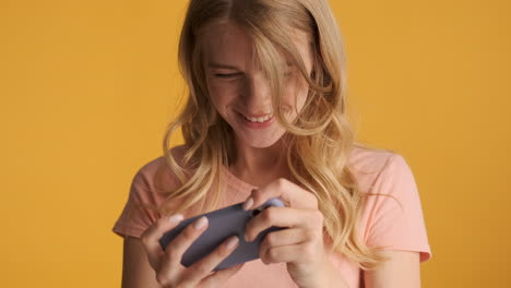 caucasian woman playing video games on smartphone.