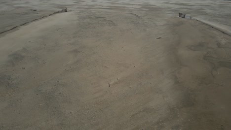 ran soaked sand on a lovely beach during a storm