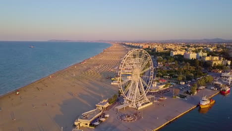 ferris wheel in rimini beach at sunset - aerial shot