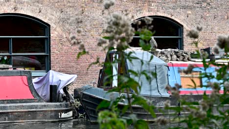 walking past boats on regents canal, london, united kingdom