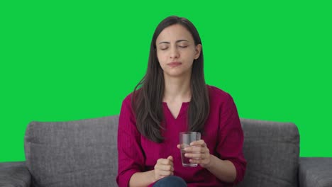 Sick-Indian-woman-taking-medicine-Green-screen