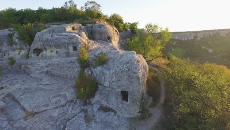 ancient rock dwellings in a mountainous landscape