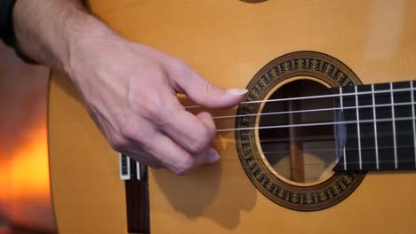 anonymous man playing song on guitar