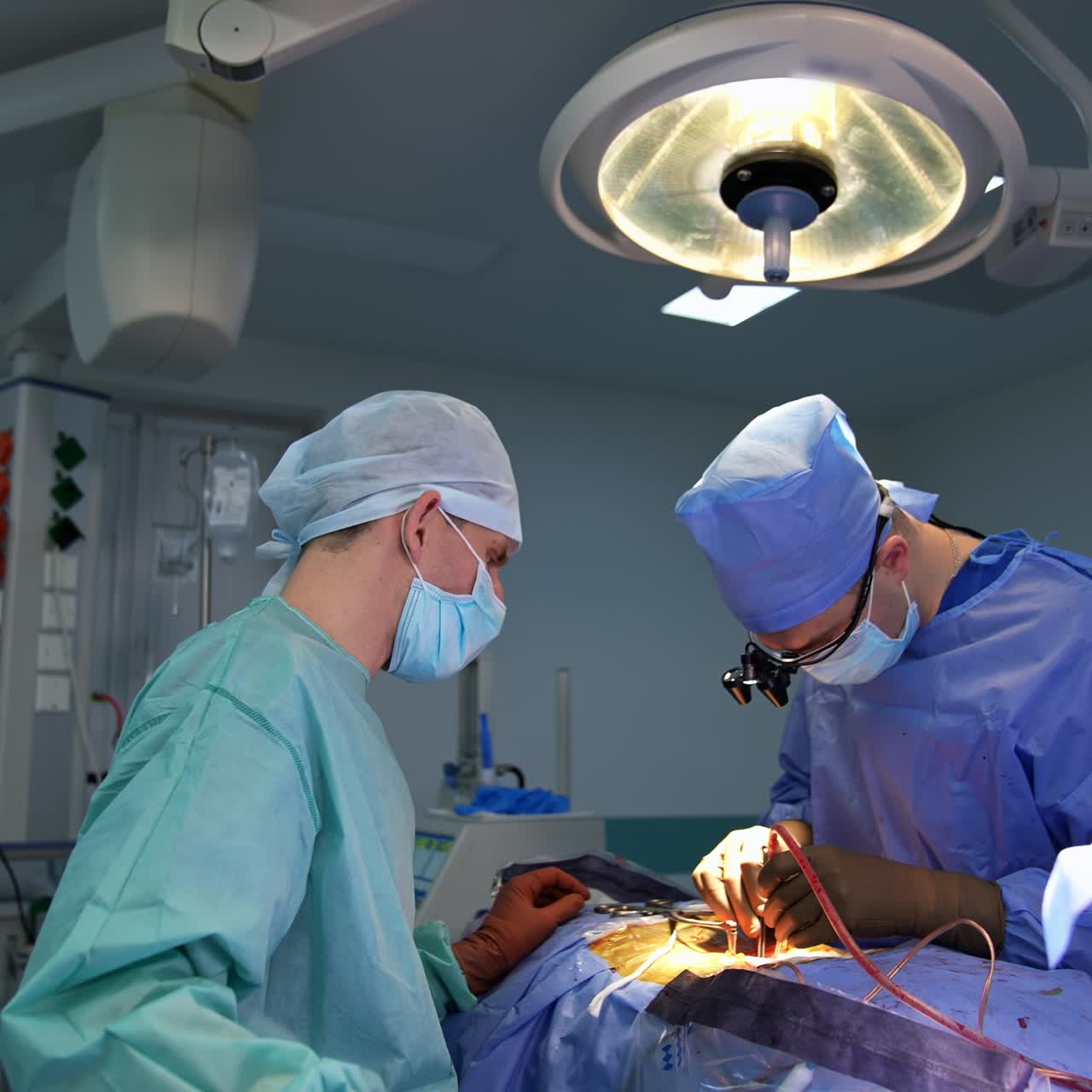 Professional neurosurgeon holds the instruments in patient's body. Assistant stand beside waiting for instructions