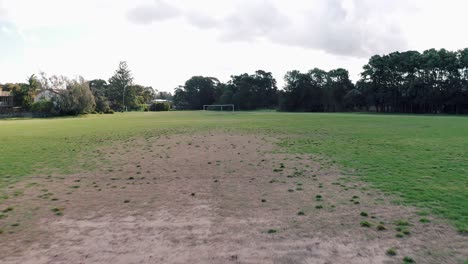 outdoor soccer field with goal posts and green forest at freshwater suburb, australia