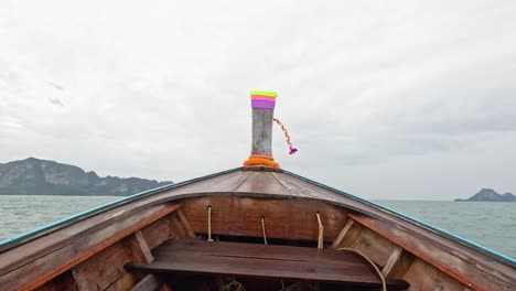 boat travels through ocean towards distant islands