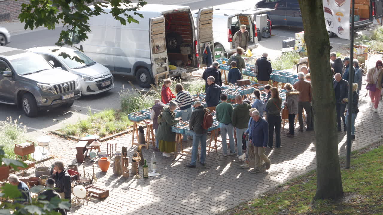 People Buying Vintage and Antique Items at the Outdoor Antiques Market in Tongeren - Sunny Day